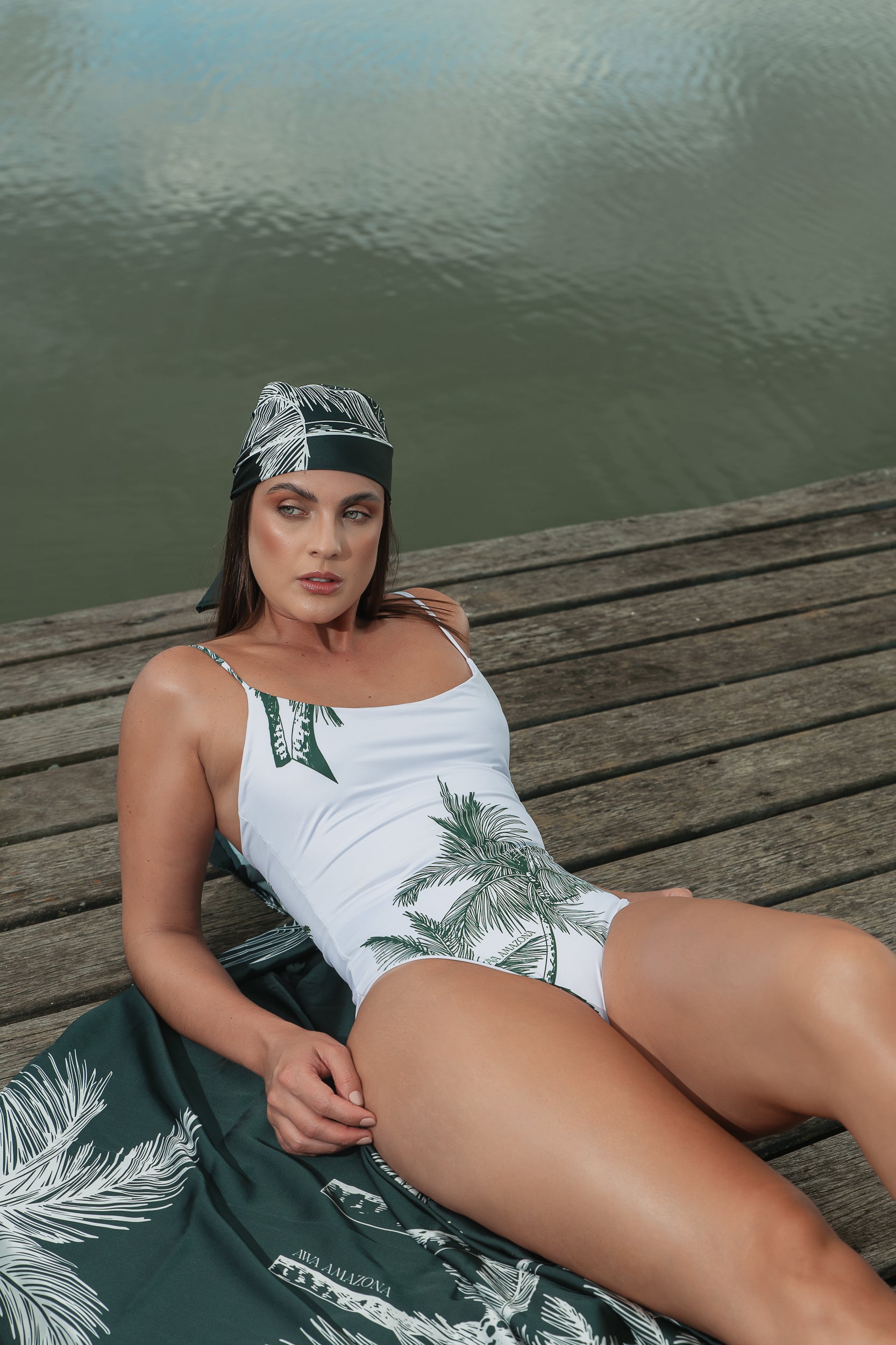 Eco-friendly reversible white and green swimsuit made from recycled ocean plastic